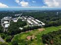 Scenic aerial view of a community near a golf course, featuring lush greenery and a glimpse of the ocean at 82 Mingo Dr. # 2D, Pawleys Island, SC 29585