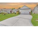 Long driveway leading to a two-car garage and a well-maintained lawn at 832 Windsor Rose Dr., Conway, SC 29526