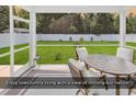 Relaxing screened-in porch with comfortable seating and a view of the backyard at 832 Windsor Rose Dr., Conway, SC 29526