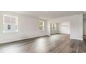 Open living room area with hardwood floors and large windows at 868 Ireland Dr., Longs, SC 29568