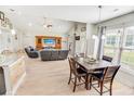 Spacious living and dining area featuring vaulted ceilings, hardwood floors, and ample natural light at 1013 Happy Ln., Galivants Ferry, SC 29544