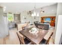 Open-concept living space blending the dining and living area with vaulted ceilings and hardwood floors at 1013 Happy Ln., Galivants Ferry, SC 29544