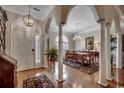 Elegant dining room featuring hardwood floors, decorative columns, and a chandelier at 1017 Coral Reef Dr., North Myrtle Beach, SC 29582