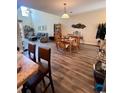 Open-concept dining area features wood floors and a table set for four at 1048 Fairway Ln. # 1048, Conway, SC 29526