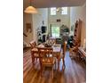 Open-concept living and dining area with high ceilings, wood floors, and large windows at 1048 Fairway Ln. # 1048, Conway, SC 29526