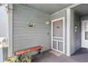 Welcoming condo entryway with a bench, cute wall decor and a cozy covered outdoor space at 1101 Possum Trot Rd. # D201, North Myrtle Beach, SC 29582