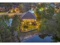 This home's backyard boasts many windows and a sprawling lawn that lead to a waterfront with a retaining wall at 1108 Surf Pointe Dr., North Myrtle Beach, SC 29582
