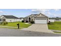 Well-maintained single-story home featuring manicured lawn and an attached two-car garage at 1205 Cymmer Ct., Conway, SC 29527