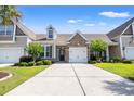 Attractive home showing the well-manicured front lawn, attached garage, and inviting stone detail around the entrance at 121 Parmelee Dr. # D, Murrells Inlet, SC 29576