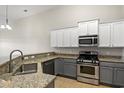 Bright kitchen showcasing granite counters, stainless appliances, modern two-tone cabinetry, and open layout at 121 Parmelee Dr. # D, Murrells Inlet, SC 29576