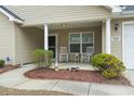 Inviting front porch with rocking chairs and tasteful decor, perfect for relaxing at 1222 Midtown Village Dr., Conway, SC 29526