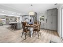 Open dining area with chandelier, seamlessly connects to the modern kitchen with island seating at 1223 Naylor Ave., Myrtle Beach, SC 29577
