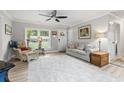 Bright living room featuring hardwood floors, ceiling fan and a large window for natural light at 1223 Naylor Ave., Myrtle Beach, SC 29577