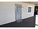 Unit 102 front door is decorated with a door wreath and welcome mat at 1310 N Waccamaw Dr. # 102, Garden City Beach, SC 29576