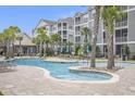 Community pool featuring curved edges, lush landscaping, palm trees and comfortable seating at 172 Ella Kinley Circle # 101, Myrtle Beach, SC 29588