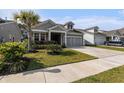 Charming single-story home with well-manicured lawn and attached two-car garage with a clear sky at 1741 Parish Way, Myrtle Beach, SC 29577