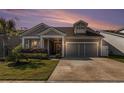 Charming single-story home with well-manicured lawn and attached two-car garage at sunset at 1741 Parish Way, Myrtle Beach, SC 29577