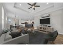Open-concept living room featuring modern furnishings, stylish decor, and seamlessly connects to dining and kitchen at 2080 Silver Island Way, Murrells Inlet, SC 29576