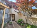 Inviting front entrance with attractive landscaping, including a Japanese maple tree, leading to a glass-paneled door at 210 Westleton Dr. # 13-D, Myrtle Beach, SC 29572