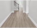Inviting hallway showcasing new flooring leading to staircase, creating a warm and stylish entry at 218 Calhoun Falls Dr., Myrtle Beach, SC 29579