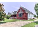 A lovely red brick home showing the side and driveway, set on a green lawn at 2191 Jasmine Rd., Loris, SC 29569