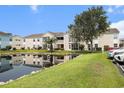 Exterior of the condo building overlooking the community pond and well-maintained landscaping at 2257 Huntingdon Dr. # H, Myrtle Beach, SC 29575
