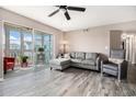 Cozy living room with wood flooring, stylish furniture, and a bright sunroom at 2257 Huntingdon Dr. # H, Myrtle Beach, SC 29575