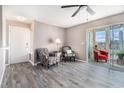 Living room featuring wood floors, neutral walls, and ample natural light from the sunroom at 2257 Huntingdon Dr. # H, Myrtle Beach, SC 29575