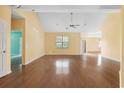 Open living room with hardwood floors, a ceiling fan, and natural light streaming through the windows creating a warm ambiance at 2384 Covington Dr., Myrtle Beach, SC 29579