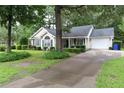 Single-story home with manicured lawn, attractive landscaping, and concrete driveway at 3001 Dewberry Dr., Conway, SC 29527