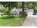 Inviting single-story home with a well-kept lawn, driveway, and decorative front yard at 3001 Dewberry Dr., Conway, SC 29527