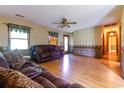 Cozy living room with hardwood floors, a ceiling fan, and lots of natural light from the window at 3150 Dusty Rd., Loris, SC 29569