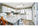 Bright kitchen boasts ample cabinet space, modern appliances, and a breakfast bar at 3308 S Ocean Blvd. # 2_B, North Myrtle Beach, SC 29582