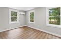 Bedroom featuring modern AC unit and hardwood floors with natural light from three windows at 3519 Cates Bay Hwy., Conway, SC 29527