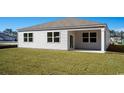 Back exterior view of home with a covered patio area and well-maintained lawn at 3562 Ashridge Way, Conway, SC 29526