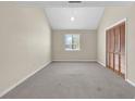 A bright bedroom with neutral carpet, a window, and a closet with louvered doors at 3700 Golf Colony Lane # 25G, Little River, SC 29566