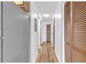 Bright hallway with wood-look flooring features closet and access to other rooms at 3700 Golf Colony Lane # 25G, Little River, SC 29566
