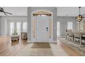 Bright foyer with tiled floors, a decorative front door with sidelights, and views of the living and dining areas at 4232 Pointer Ct., Myrtle Beach, SC 29579