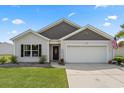 Charming single-story home with manicured lawn, two-car garage, and inviting entrance on a beautiful day at 568 Mossbank Loop, Longs, SC 29568