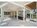 Spacious covered parking area with outdoor seating, storage room, and easy access stairs at 58 Fathom Ln., Murrells Inlet, SC 29576
