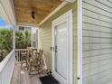 Inviting porch with rocking chairs, wood ceiling, and ceiling fan creating a relaxing outdoor space at 58 Fathom Ln., Murrells Inlet, SC 29576