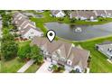 Aerial view of townhomes near a pond with fountain in a well-maintained community at 592 Riverward Dr. # 592, Myrtle Beach, SC 29588