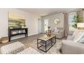 Bright living room with a decorative rug, stylish decor, and seamless flow into other areas at 597 Strawberry Field Way, Galivants Ferry, SC 29544