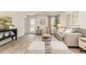 Inviting living room with wood-look floors, stylish furniture, and a bright, airy atmosphere at 597 Strawberry Field Way, Galivants Ferry, SC 29544