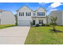 Charming two-story home with a well-maintained lawn, attached garage and inviting front porch at 625 Heritage Downs Dr., Conway, SC 29526