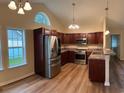 Kitchen featuring stainless steel appliances, dark wood cabinets, and granite countertops at 753 Bucklin Loop, Myrtle Beach, SC 29579
