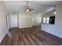Open concept living room with wood floors, ceiling fan, and view of the kitchen at 753 Bucklin Loop, Myrtle Beach, SC 29579