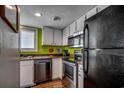 Updated kitchen with modern stainless steel appliances and crisp white cabinetry at 806 N Waccamaw Dr. # 304, Garden City Beach, SC 29576