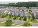 Aerial view of a neighborhood featuring well-maintained townhomes with manicured lawns and mature trees at 816 Barn Owl Ct. # 816, Myrtle Beach, SC 29579