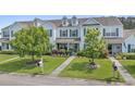 Inviting townhome with blue shutters, green lawn, mature trees, and a welcoming front yard at 816 Barn Owl Ct. # 816, Myrtle Beach, SC 29579